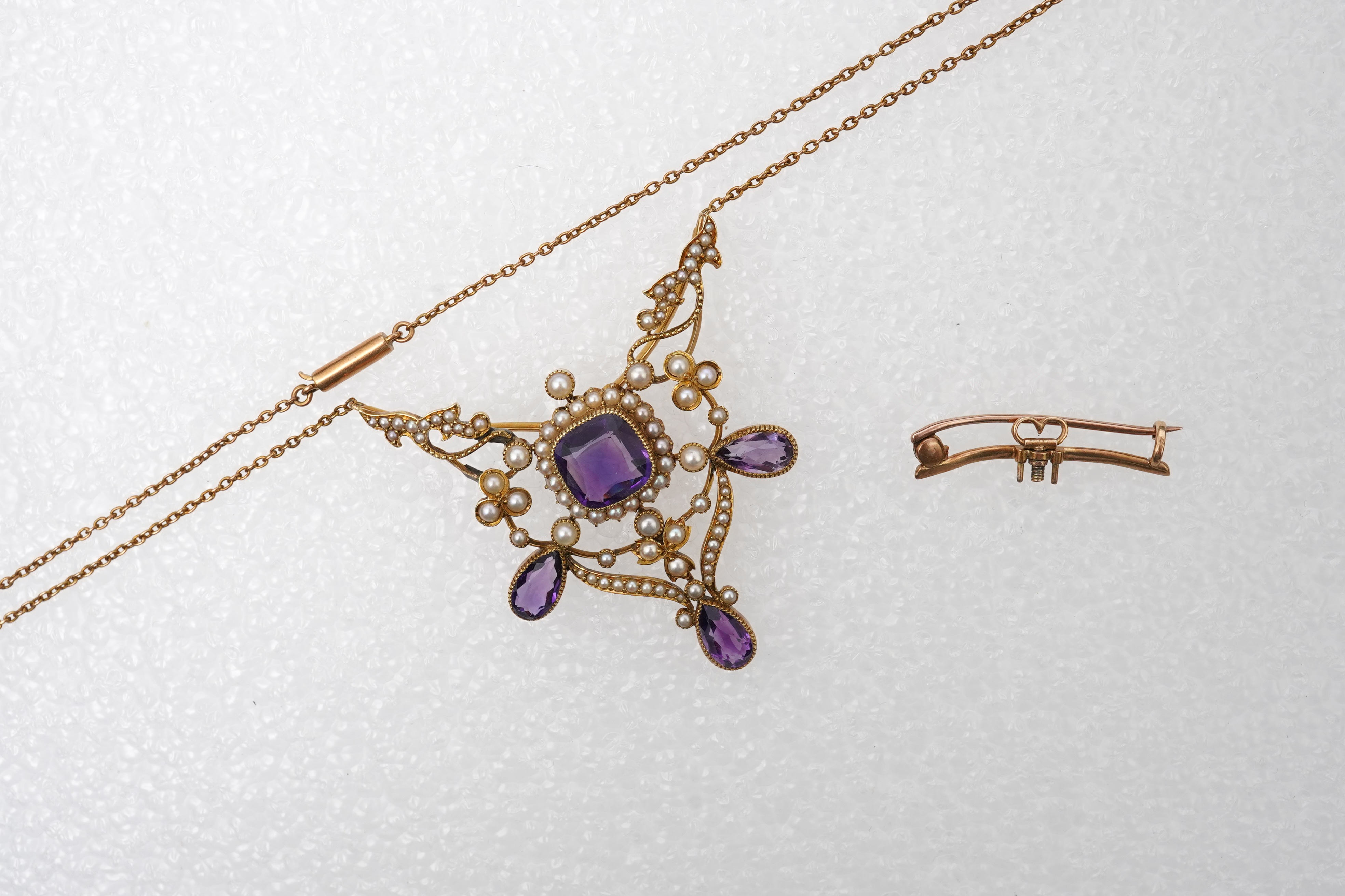 An Edwardian seed pearl and amethyst pendant/brooch, early 20th century